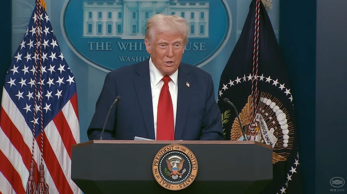 Donald Trump speaking at a press conference in front of the White House seal, addressing aviation safety and criticizing DEI policies.