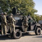 For More Sports And Politics Content: Secretary of Homeland Security Kristi Noem, not shown, visits with U.S. Immigration and Customs Enforcement officers at the ICE facility in Chicago to observe enforcement operations, Oct. 3, 2025. (DHS photo by Tia Dufour)