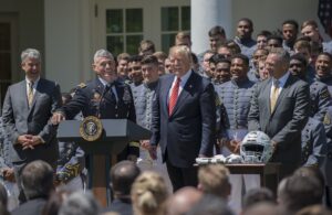 Lt. Gen. Robert L. Caslen Jr., the U.S. Military Academy superintendent, shares a laugh with President Donald Trump during the presentation of the Commander-in-Chief's Trophy, which the Army football team earned after it beat Navy and Air Force last season. Players also gave the president a team helmet and jersey during the ceremony at the White House in Washington, D.C., May 1, 2018. (Photo Credit: U.S. Army photo by Sean Kimmons)